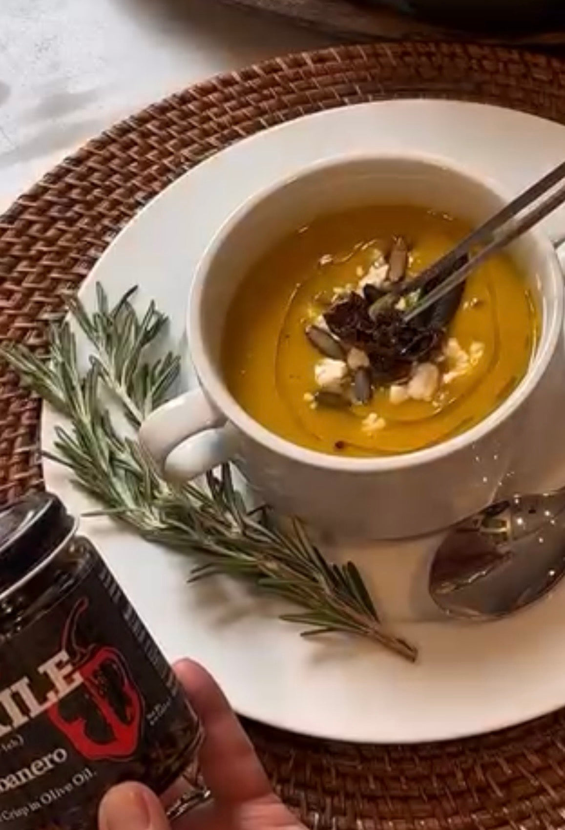 Butternut squash soup topped with Al Xile Habanero Chile Crisp and fresh rosemary