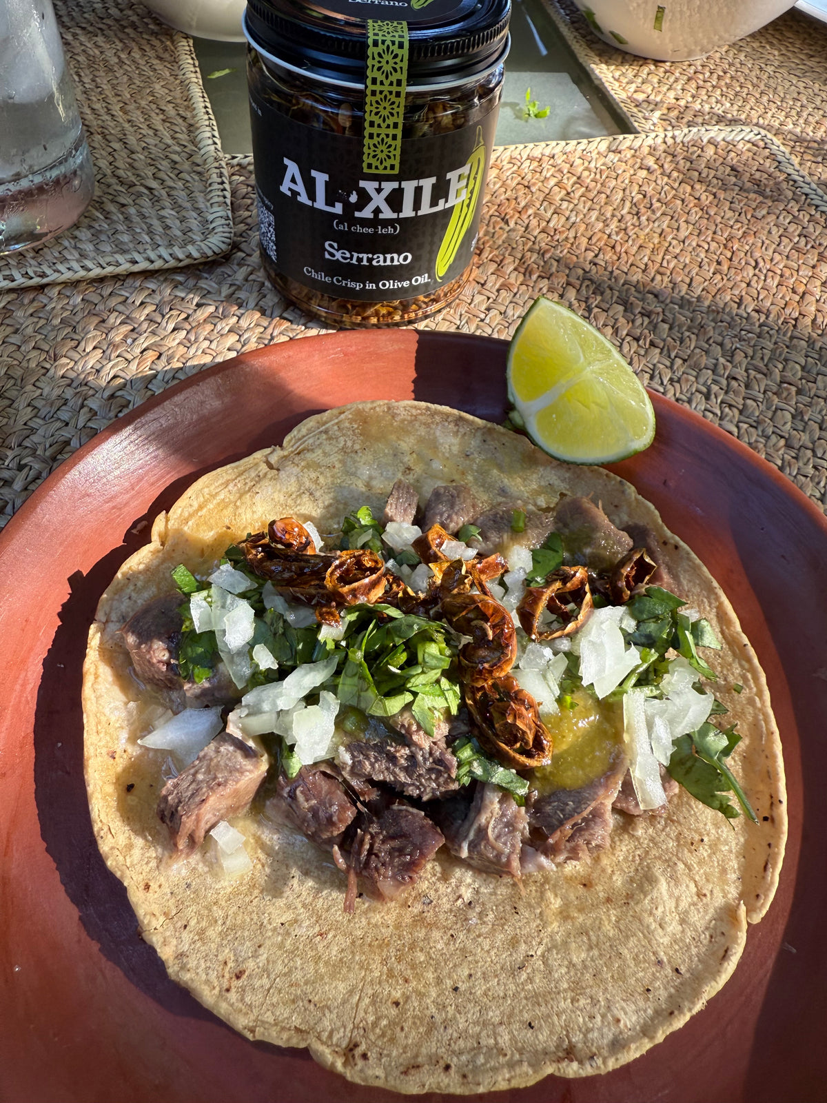 Tacos de lengua with Al Xile Serrano Chile Crisp, onion, cilantro and lime