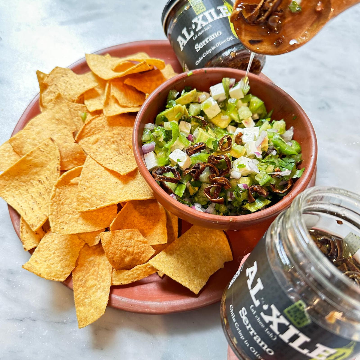 Panela ceviche with avocado, cilantro and Al Xile Serrano Chile Crisp served with tortilla chips